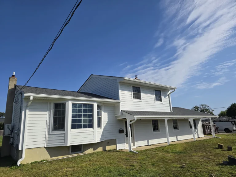 White lap siding and new windows on a renovated split-level home in New Jersey by Keystone
