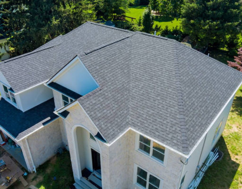 Roofing specialists inspecting residential roof in Middletown NJ